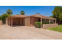 Single-Gathering home with attached carport and desert landscaping on a sunny day at 1810 N 74Th St, Scottsdale, AZ 85257