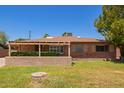 Charming brick home with a covered front porch and a well-maintained lawn at 1810 N 74Th St, Scottsdale, AZ 85257