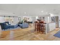 Open-concept living area with hardwood floors, modern furniture, and abundant natural light at 1831 E Rovey Ave, Phoenix, AZ 85016