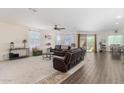 Spacious living room with plush carpeting, comfortable seating, and ample natural light at 18581 W College Dr, Goodyear, AZ 85395