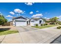 Spacious home with a three-car garage, manicured lawn, and desert landscaping in a desirable neighborhood at 19160 E Canary Way, Queen Creek, AZ 85142