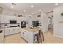 Bright kitchen featuring a center island, white cabinetry, stainless steel appliances, and tile flooring at 19160 E Canary Way, Queen Creek, AZ 85142