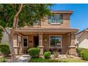 Inviting two-story home with a covered front porch, decorative accents, and well-maintained landscaping at 2048 S Martingale Rd, Gilbert, AZ 85295