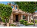 Charming residence featuring a welcoming front porch, neat landscaping, and an inviting curb appeal at 2048 S Martingale Rd, Gilbert, AZ 85295