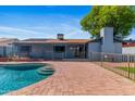 Serene backyard featuring a pristine pool, brick patio, and private outdoor space at 2114 E Sesame St, Tempe, AZ 85283
