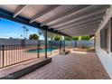 Charming covered patio overlooking the backyard, complete with a brick-paved area and perimeter fence at 2114 E Sesame St, Tempe, AZ 85283