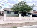 Charming single story home featuring a well-sized yard and large mature tree, complete with a paved walkway at 2310 N 40Th Dr, Phoenix, AZ 85009