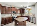Spacious kitchen with dark cabinets, granite countertops, stainless steel appliances, and a center island at 2762 E Clifton Ave, Gilbert, AZ 85295