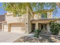Charming two-story home with a three-car garage, covered entry and well-maintained front yard landscaping at 28054 N Jade St, San Tan Valley, AZ 85143