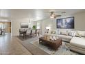 Beautifully staged living and dining area, complete with stylish furnishings and neutral color palettes at 28054 N Jade St, San Tan Valley, AZ 85143