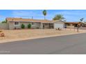 Exterior of the home featuring desert landscaping with charming shrubs and trees at 301 N 87Th St, Mesa, AZ 85207