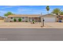 Charming single-story home with desert landscaping, a covered porch, and an attached two-car garage at 301 N 87Th St, Mesa, AZ 85207
