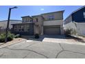 Exterior view of a two story home with a two-car garage and low-maintenance landscaping at 359 N 157Th Ln, Goodyear, AZ 85338