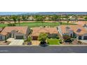 Charming single-story home with a well-manicured lawn, mature trees, and a welcoming curb appeal in a golf community at 3702 N 160Th Ave, Goodyear, AZ 85395