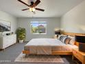 Comfortable bedroom featuring neutral colors, a ceiling fan, and a bright window at 37711 W Bello Ln, Maricopa, AZ 85138