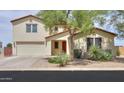 Charming single-Gathering home with a well-manicured yard, mature trees, and two-car garage at 40232 W Marion May Ln, Maricopa, AZ 85138