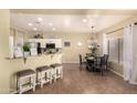 Open kitchen and dining area with granite countertops and stylish decor at 4516 W Fortune Dr, Phoenix, AZ 85086