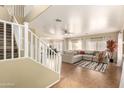 Spacious living room with tile floors, neutral decor, and staircase at 4516 W Fortune Dr, Phoenix, AZ 85086