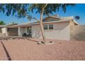 Inviting home with mature shade tree, xeriscaped yard, covered front porch, and attached garage at 4549 W Poinsettia Dr, Glendale, AZ 85304