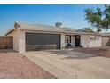 Attractive home featuring a large garage, covered entry and tidy xeriscaped front yard at 4549 W Poinsettia Dr, Glendale, AZ 85304