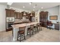 Modern kitchen with large island, seating, stylish pendant lights, and stainless appliances at 4822 N Barranco Dr, Litchfield Park, AZ 85340
