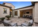 Cozy outdoor patio with fireplace, comfortable seating, and inviting decor at 4822 N Barranco Dr, Litchfield Park, AZ 85340