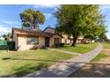 Charming single-story home with a well-maintained lawn and mature shade trees at 6120 N 30Th Ave, Phoenix, AZ 85017