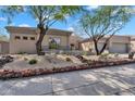 Beautiful home showcasing desert landscaping and mature trees in the front yard at 6184 E Dusty Coyote Cir, Scottsdale, AZ 85266
