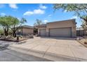 Attractive home featuring desert landscaping, a spacious driveway, and a three-car garage at 6184 E Dusty Coyote Cir, Scottsdale, AZ 85266