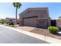 Two car garage with brick trim and paved brick driveway at 6202 E Mckellips Rd # 183, Mesa, AZ 85215