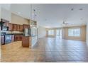 Open-concept kitchen with dark cabinetry, a kitchen island, and tiled flooring connecting to living areas at 637 E Settlers Trl, Casa Grande, AZ 85122