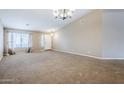 Bright living room showcasing neutral walls, carpet flooring and direct access to the front entrance at 637 E Settlers Trl, Casa Grande, AZ 85122