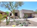Charming home with rock landscaping, mature tree, and two-car garage at 6939 E Bramble Berry Ln, Scottsdale, AZ 85266
