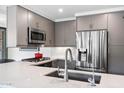 Well-equipped kitchen with stainless steel appliances and gray cabinetry, highlighting contemporary design at 7141 E Rancho Vista Dr # 6007, Scottsdale, AZ 85251