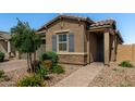 Beautiful single story home with decorative shutters, stone accents, paver walkway, and meticulous desert landscaping at , Avondale, AZ 85323