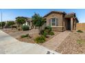 Attractive home with a paver driveway, stone accents, manicured landscaping, and a welcoming front entrance at , Avondale, AZ 85323