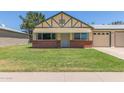 Charming single-Gathering home featuring a well-maintained front yard and a two-car garage at 10201 N 97Th Ave # B, Peoria, AZ 85345