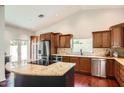 Well-lit kitchen boasting a large island with seating, stainless steel appliances, and hardwood floors at 10522 E Bella Vista Dr, Scottsdale, AZ 85258
