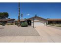 Inviting single-level home with a well-maintained front yard and a convenient two-car garage at 10858 E Sahuaro Dr, Scottsdale, AZ 85259