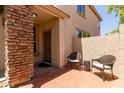 Cozy brick-paved front patio with seating, leading to the home's entrance at 13420 W Berridge Ln, Litchfield Park, AZ 85340