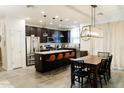 Open kitchen with stainless steel appliances, granite countertops, and seating at the kitchen island at 14344 W Hackamore Dr, Surprise, AZ 85387