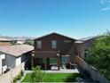 A landscaped backyard boasts a cozy patio with green lawn, ideal for outdoor living and entertaining at 20217 W Desert Bloom St, Buckeye, AZ 85326