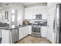 Bright kitchen featuring white cabinets, stainless steel appliances and a kitchen island at 20217 W Desert Bloom St, Buckeye, AZ 85326