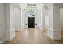Grand foyer with soaring ceilings, hardwood floors, and an ornate chandelier hanging above at 210 E Cactus Wren Dr, Phoenix, AZ 85020