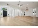 Open-concept living room with hardwood floors, modern lighting, and arched doorways to other rooms at 210 E Cactus Wren Dr, Phoenix, AZ 85020