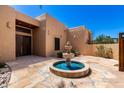 Inviting front yard featuring a beautiful water fountain and desert landscaping at 22050 N 90Th St, Scottsdale, AZ 85255