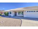 Charming single-story home featuring desert landscaping, a tile roof, and a cozy front porch at 2317 E Lynwood St, Mesa, AZ 85213