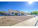 Well-maintained single-story home featuring a tile roof and low-maintenance desert landscaping at 2317 E Lynwood St, Mesa, AZ 85213