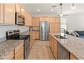Spacious kitchen boasts stainless steel appliances, granite countertops, and an open design for modern living at 24580 N 144Th Ave, Surprise, AZ 85387