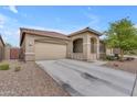 Inviting home with a spacious driveway, two-car garage, and a cozy, covered porch area at 25202 N 106Th Dr, Peoria, AZ 85383